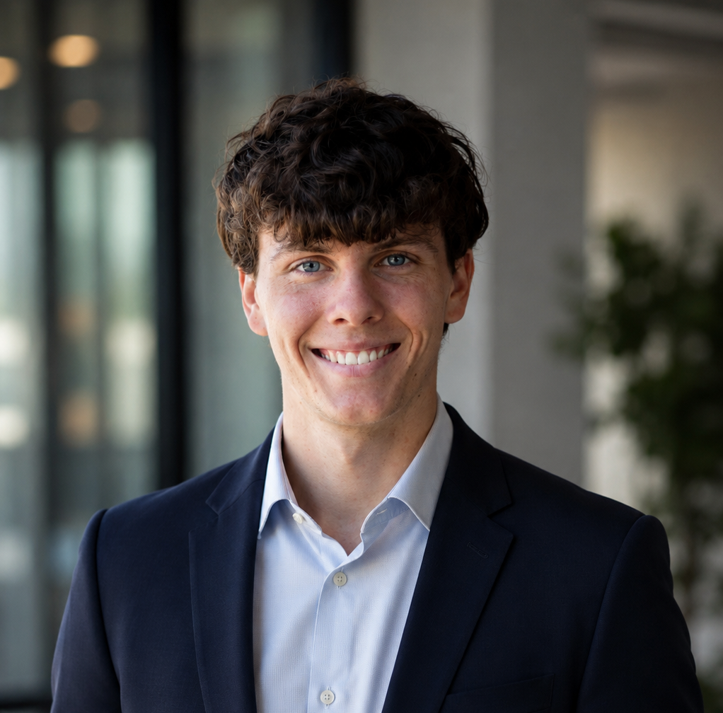 Matthew Moore wearing a navy jacket and light blue shirt
